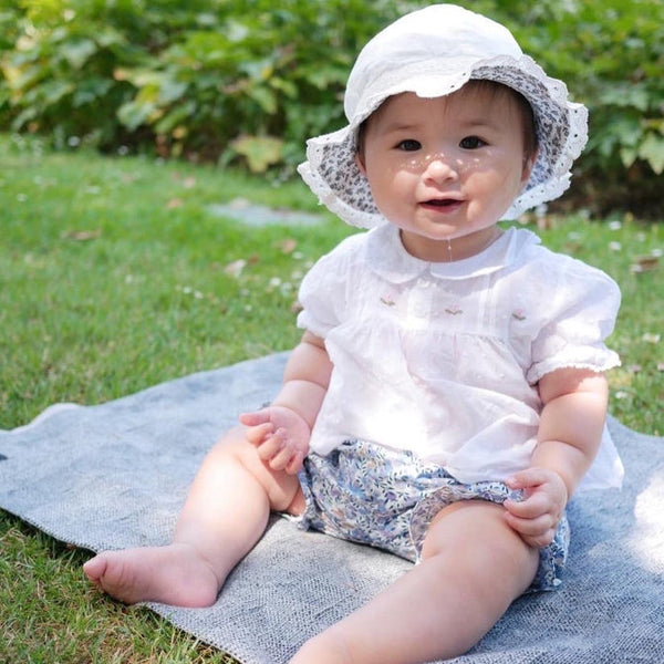 Baby in white blouse and Harriet bloomers